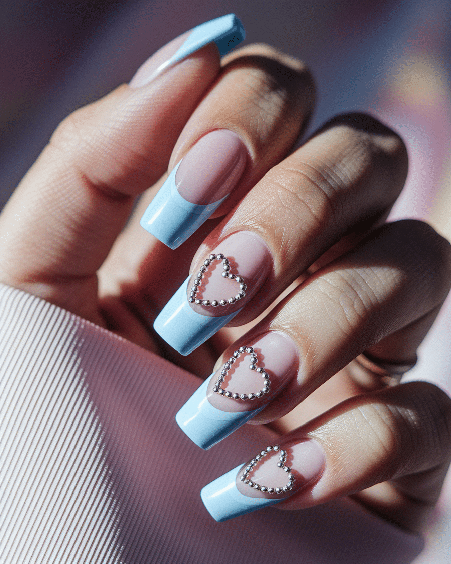 Elegant Minimalist Nail Trends with Blue French Tips and Heart Accents