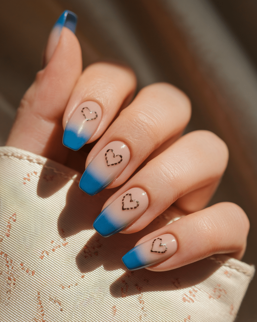 Elegant Minimalist Nail Trends with Blue French Tips and Heart Accents