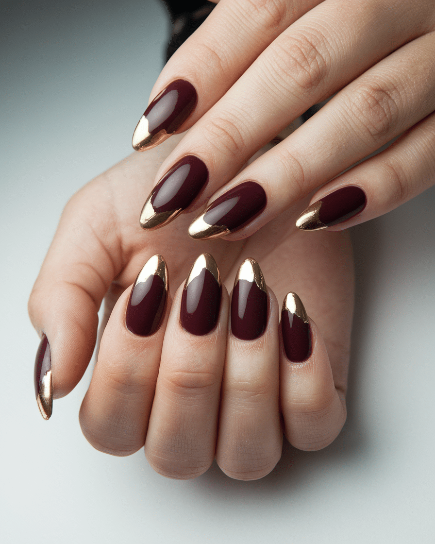 0012_1_a-still-of-a-beautiful-hand-with-nails-o_H879sgvXScuRDx0BXZ-4Yg_NAi96LqPT3ueKYvF8Ue5ZQ The Timeless Elegance of Burgundy and Gold Nails