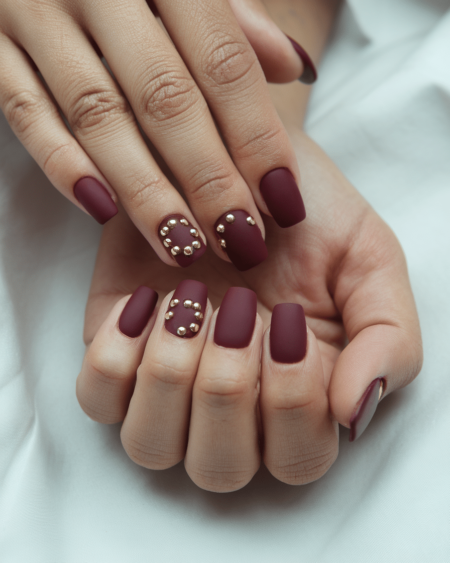 0016_3_a-still-photo-of-a-beautiful-hand-with-n_UAY4TI7RRFyhzZmaimc4Ug_glMPvOsCQheKuY6aVJzn1A The Timeless Elegance of Burgundy and Gold Nails