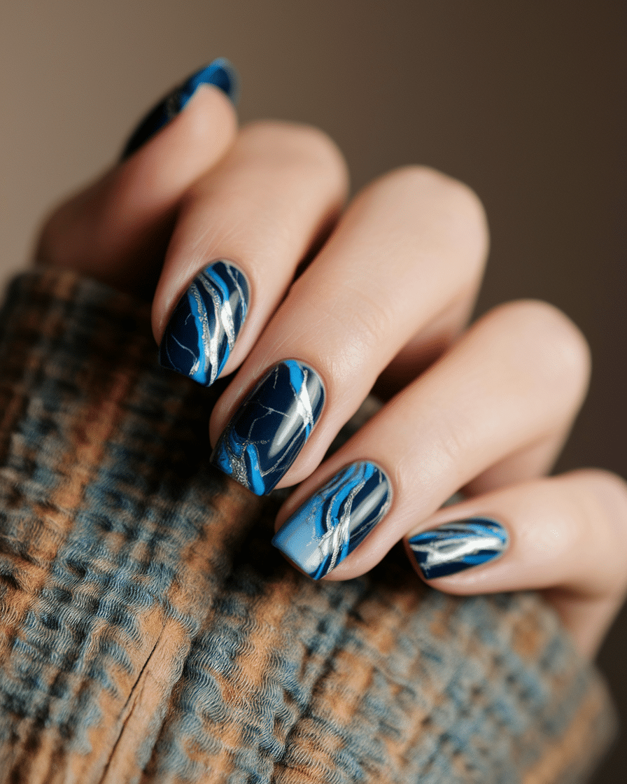 0003_1_a-close-up-photograph-of-a-hand-with-ele_-qNH8XKVTQyOwijT9lHAPw_LhvuJm7BR1yGTUxDfr1Mog_cover Blue Nail Designs for a Fresh, Modern Look in 2025