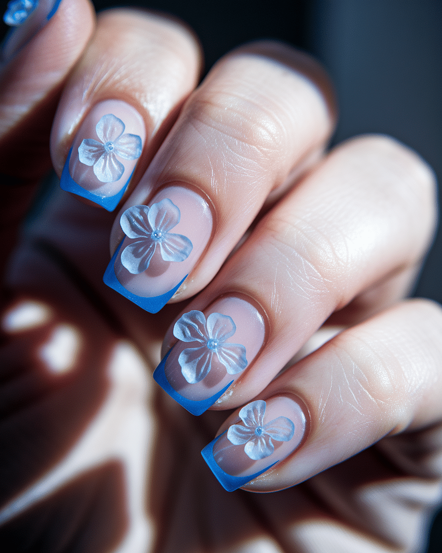 0003_2_a-close-up-photograph-of-a-hand-with-she_VBS1dLXITaagKW8-jQz8qQ_JuCV0fNtSFO3KFlDpndCTA Elegant Floral Nail Designs with a Fresh Blue Twist