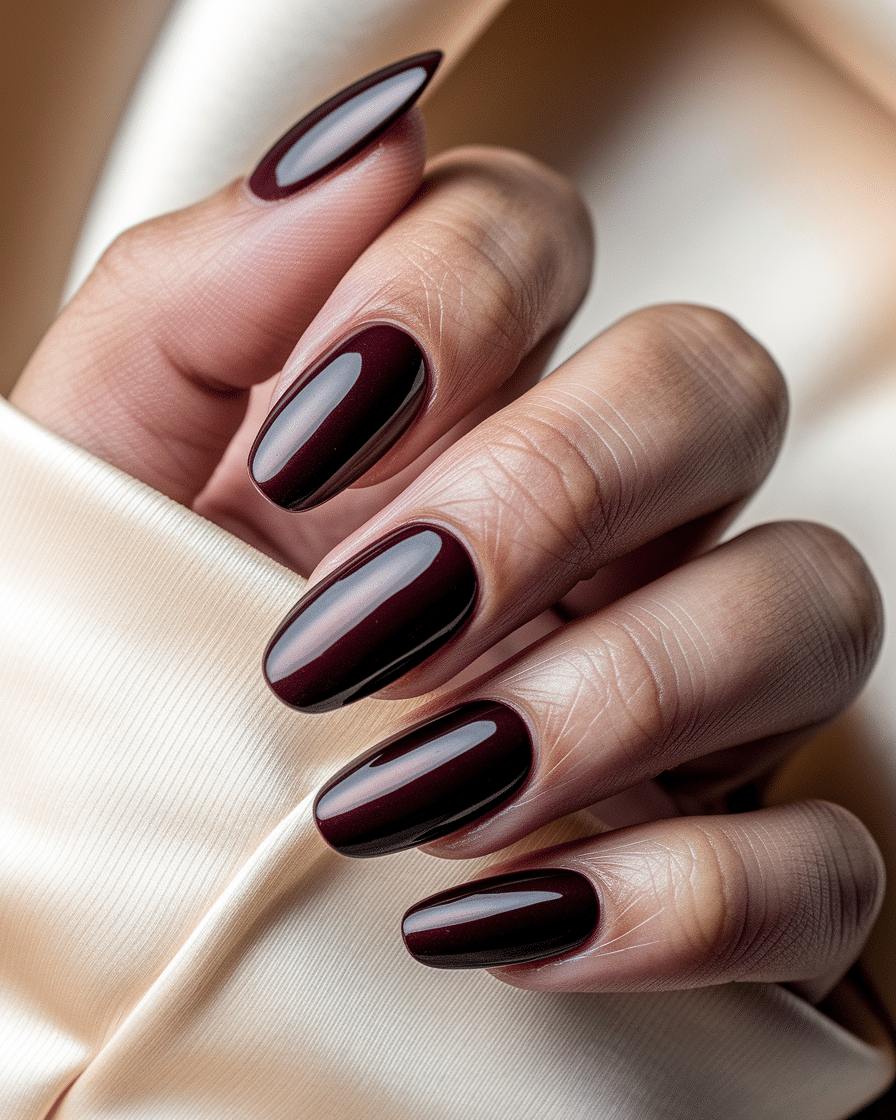 0009_3_a-close-up-photograph-of-a-hand-with-lux_xm8SfxXISXaeGGz1ot9Y7A_56N6HwhOSCqq-GfItlmSow Burgundy Nail Ideas for a Timeless and Elegant Manicure